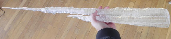 Hand holding large icicle