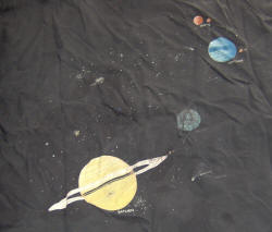 The solar system on a T-shirt.  Kind of old and faded, but the model was even older.