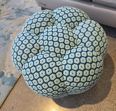 This Pouff will be re-covered in a cloth of an appropriate color. I don't remember which on but I'm sure I'll like it.