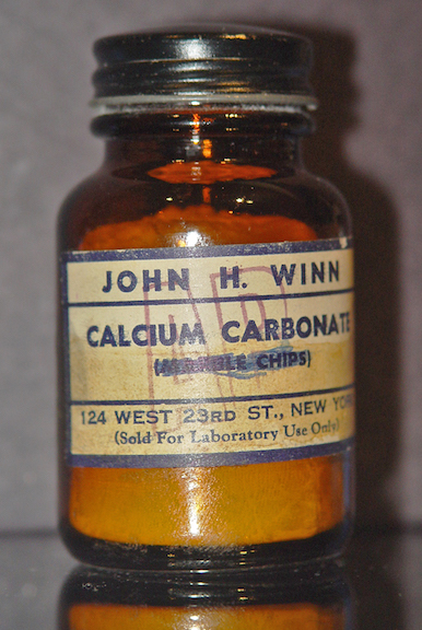 Bottle of calcium carbonate (marble chips scratched out on the label)